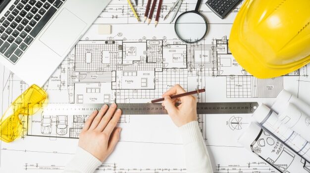 architect-using-ruler-blueprint_23-2147710952